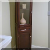 F19. Tall brown cabinet. 65”h x 15”w x 12”d 